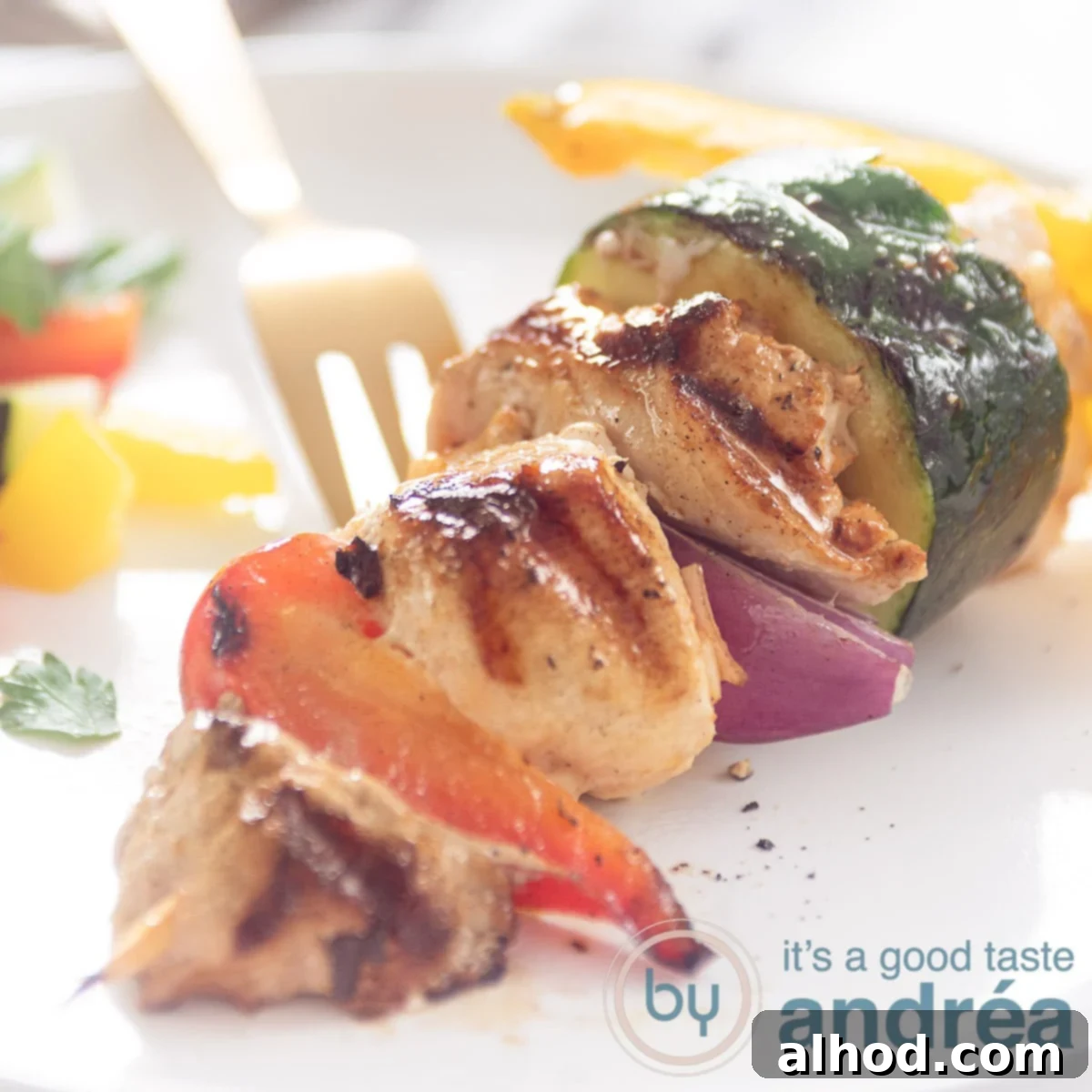 How to Grill Perfect Shashlik 5 A square photo with a pork tenderloin, chicken and vegetable skewer on a white plate