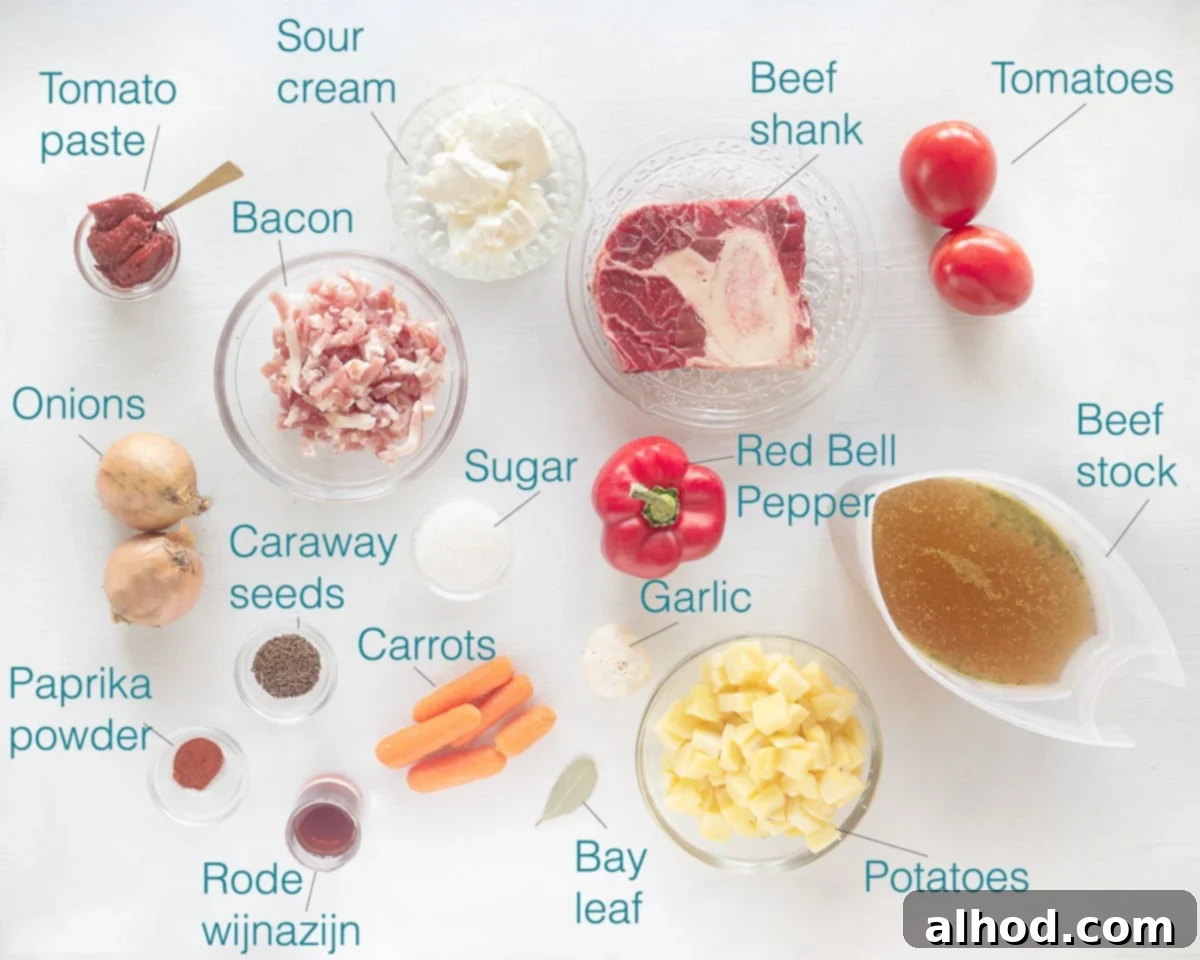 Hearty Slow Cooker Beef Goulash Soup 3 Individually labeled ingredients to make crock pot goulash soup laid out on a white background