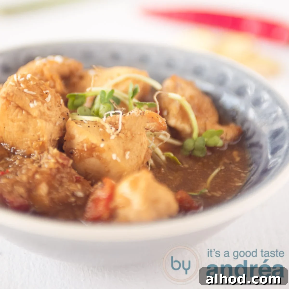 Balinese Spiced Chicken Ayam Bumbu Bali 6 A square photo with a grey bowl filled with balinese chicken cubes in a delicoius sauce on a white background