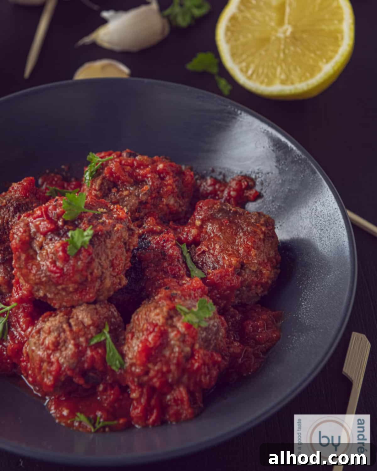 Spanish Tapas Albondigas 5 A gray bowl with albondigas, Spanish meatballs in tomato sauce.
