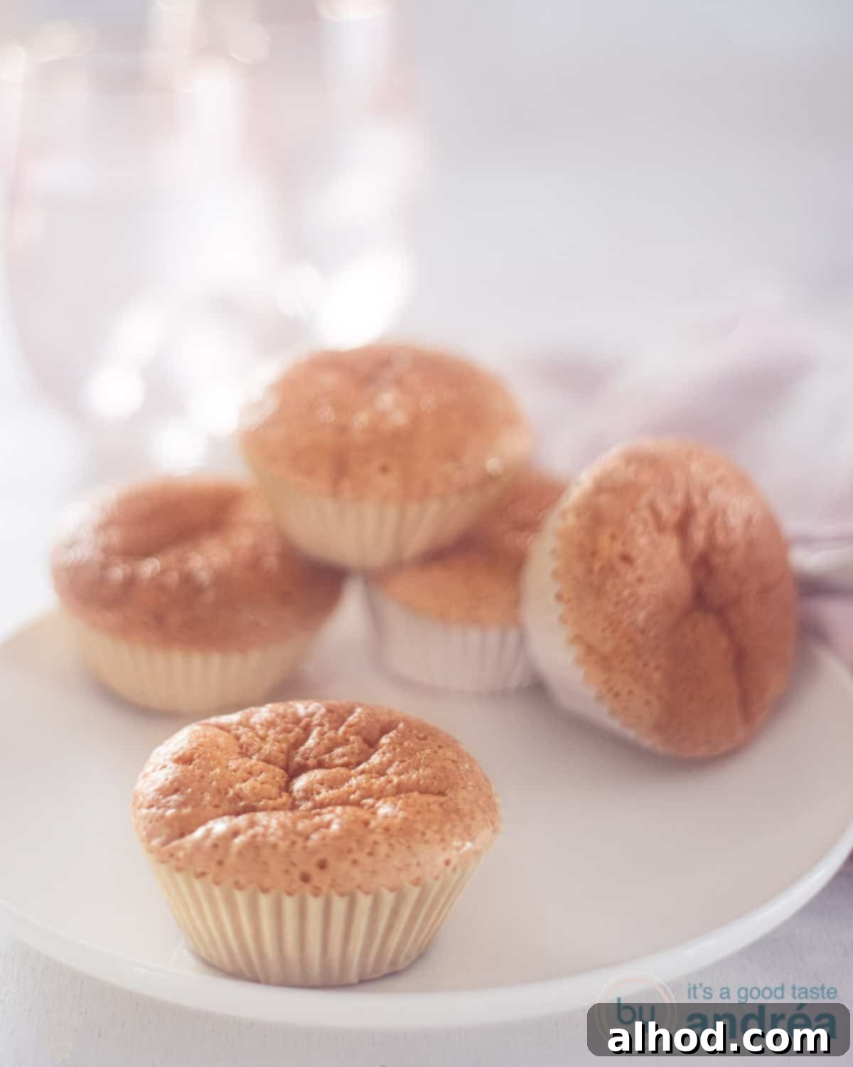 Creamy Milk Cupcakes 3 5 sweet milk cupcakes on a white plate. A white background, highlighting their simple elegance and delicious appeal, ready to be enjoyed.