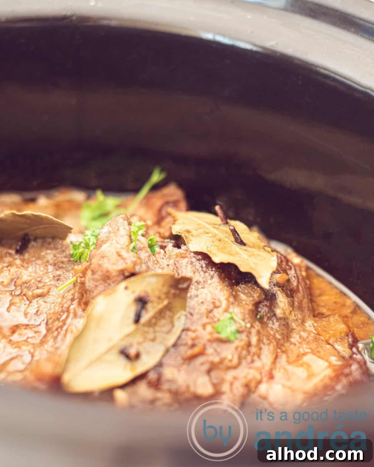 Dutch Slow-Braised Pot Roast 2 Part of the slow cooker filled with pulled pork. Garnish with bay leaves, cloves and parsley.