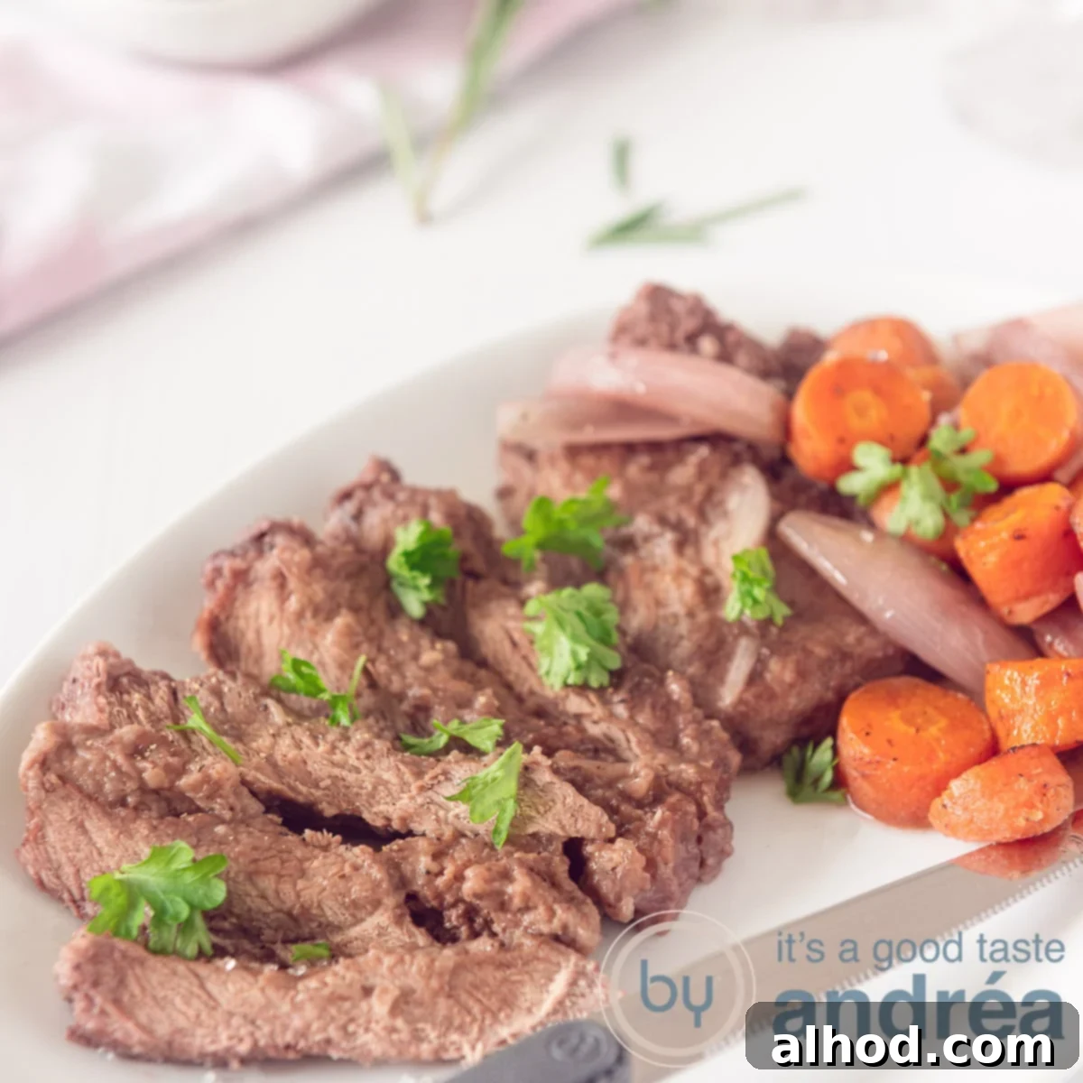 Succulent Roasted Sirloin with Deep Red Wine Sauce 6 A square photo with strips of sirloin steak garnished with parsley and served with shallot and carrots