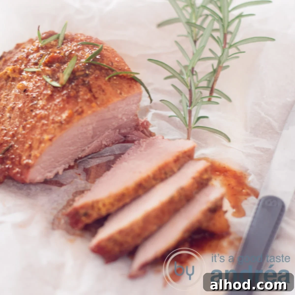 Tender Slow Cooker Fresh Ham 6 A square photo with a ham cut with three slices and gravy in front. A baking paper underneath and rosemary on top.