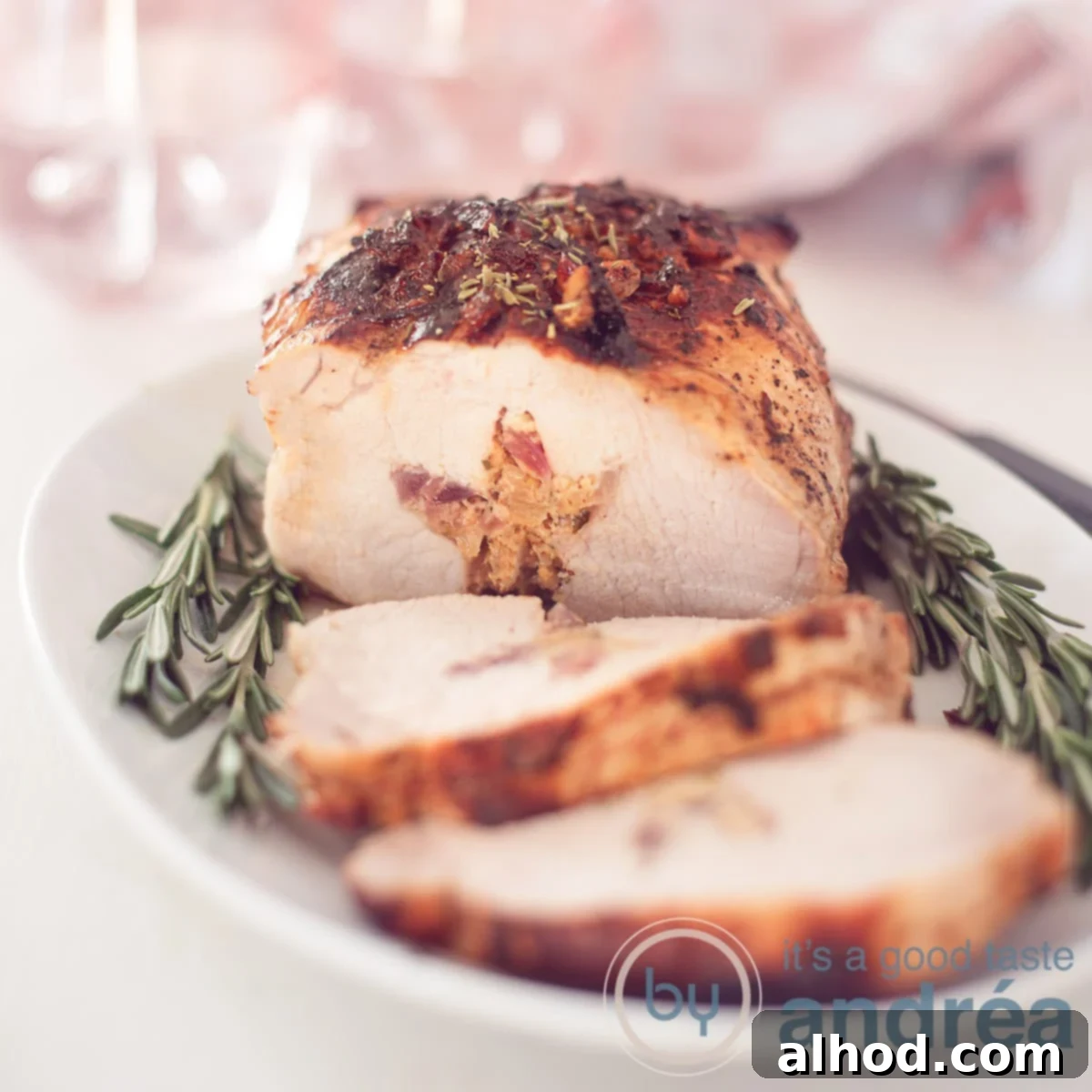 Traditional Dutch Rolled Roast 6 A square photo with a white dish with rosemary and a stuffed roulade with onion, honey and thyme.