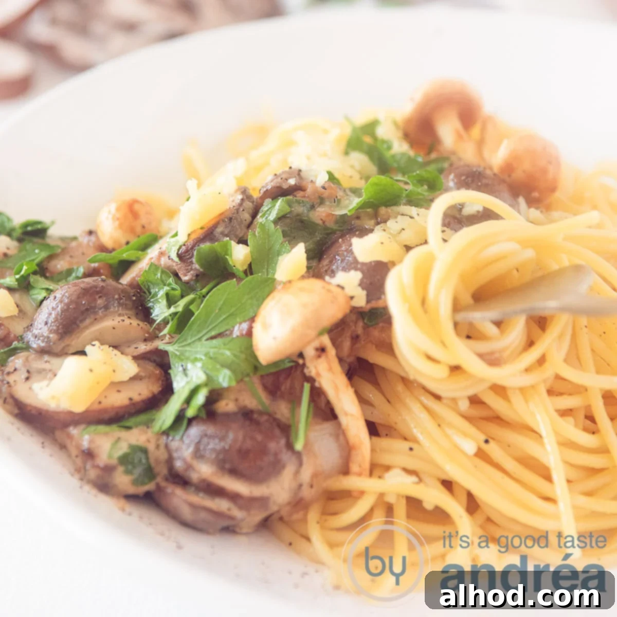 Luscious Creamy Garlic Mushroom Pasta 6 A square photo with spaghetti with mushrooms in cream sauce