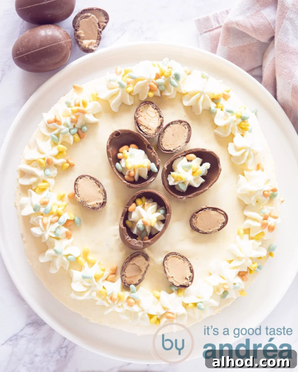 Effortless Holiday Eggnog Cheesecake 5 A photo from above of a no bake cheesecake with eggnog, decorated with chocolate Easter eggs and whipped cream.