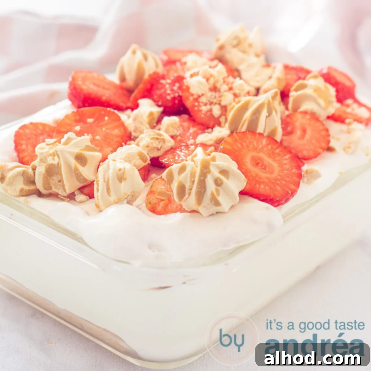 Luscious Egg-Free Strawberry Tiramisu 6 A square photo with a glass bowl filled with strawberry tiramisu on a white background
