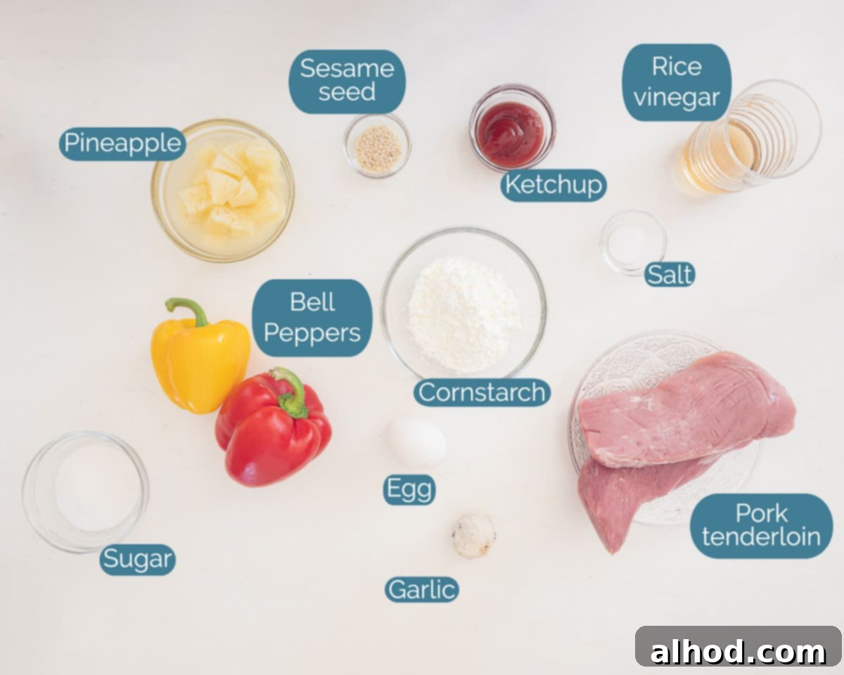 Sweet and Sour Pork 3 Ingredients for Sweet and Sour Pork, including pork tenderloin, cornstarch, egg, oil, garlic, bell peppers, pineapple, sugar, rice vinegar, tomato ketchup, and sesame seeds, individually labelled on a marbled white background.