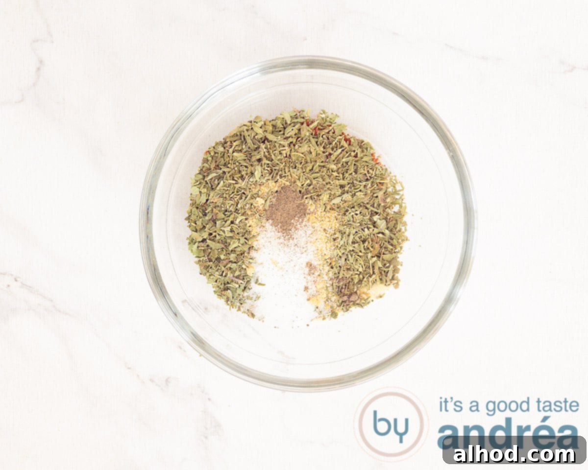Authentic Homemade Gyros Seasoning 4 The different spices for the gyros spice mix in a glass dish collected on a white marbled background