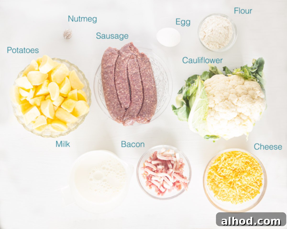 Savory Cheesy Sausage and Cauliflower Bake 3 Various fresh ingredients for Cheesy Sausage and Cauliflower Casserole, including potatoes, cauliflower, sausage, cheese, and milk, arranged on a white background.