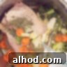 Water is poured into the pan with the chicken, vegetables and herbs