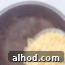 Vermicelli noodles are added to the pot of chicken soup