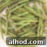 Crispy Sesame Green Beans 4 A white frying pan in which green beans are stir-fried.