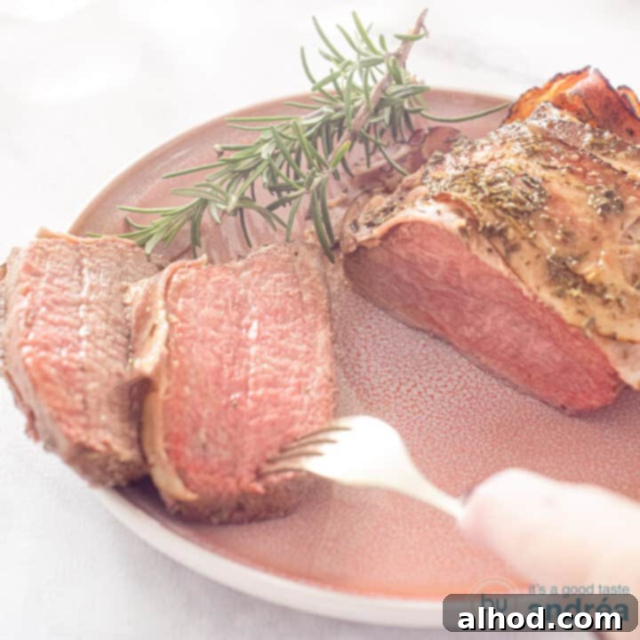 A square photo of roast beef with bacon, two slices of which have been cut off. A fork pierces a slice