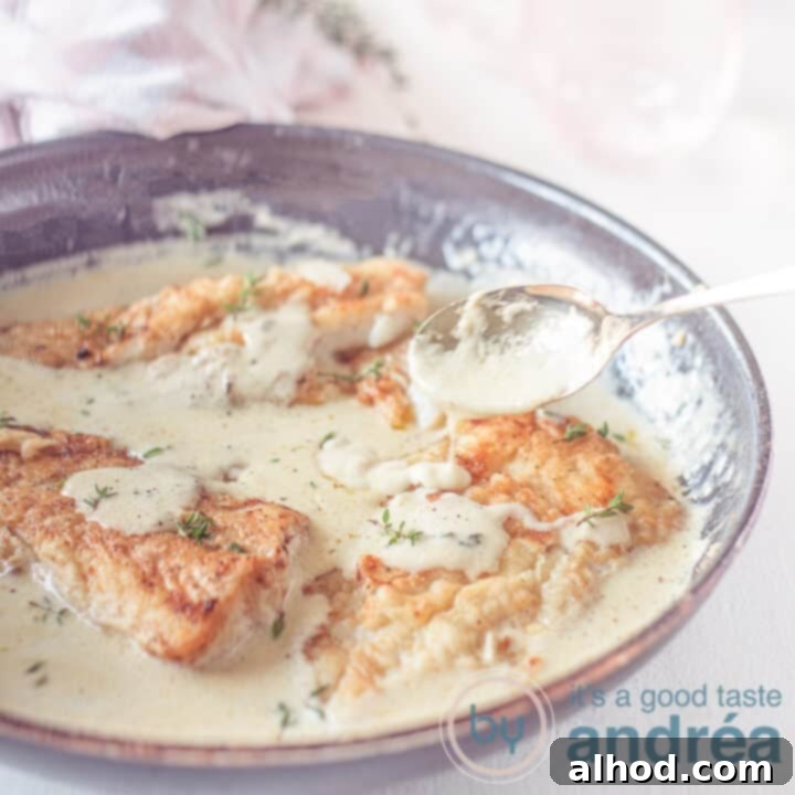 24 Festive Christmas Dinner Recipes 22 A square photo with a skillet filled with cod and a creamy white wine lemon sauce.