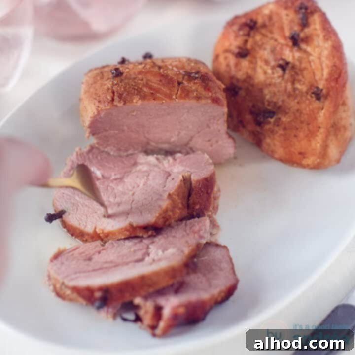 A square photo with two hams covered with a cola mustard sauce. Three slices cut off. A fork pierces a slice