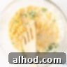 A bowl with Corn Fritter batter with corn and parsley