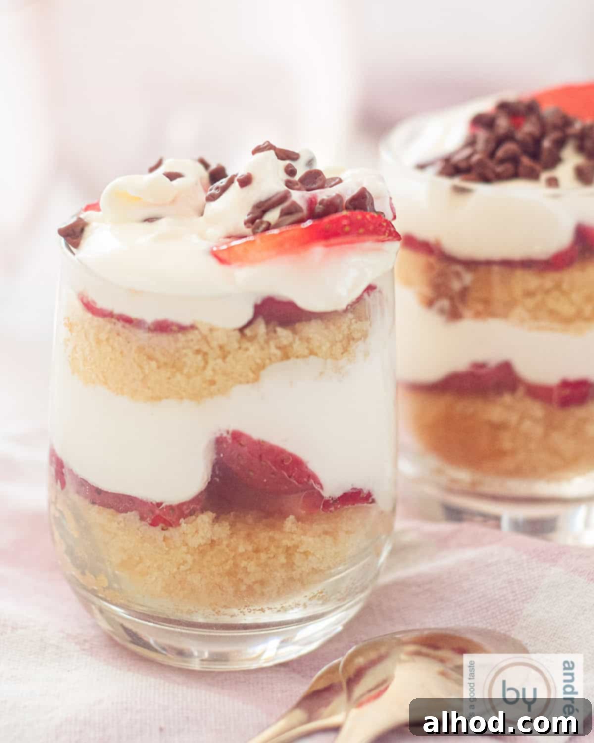 Strawberry Pound Cake Mini Trifles 2 A height photo with two glasses filled with layers of cake, fresh strawberries, mascarpone cream alternating