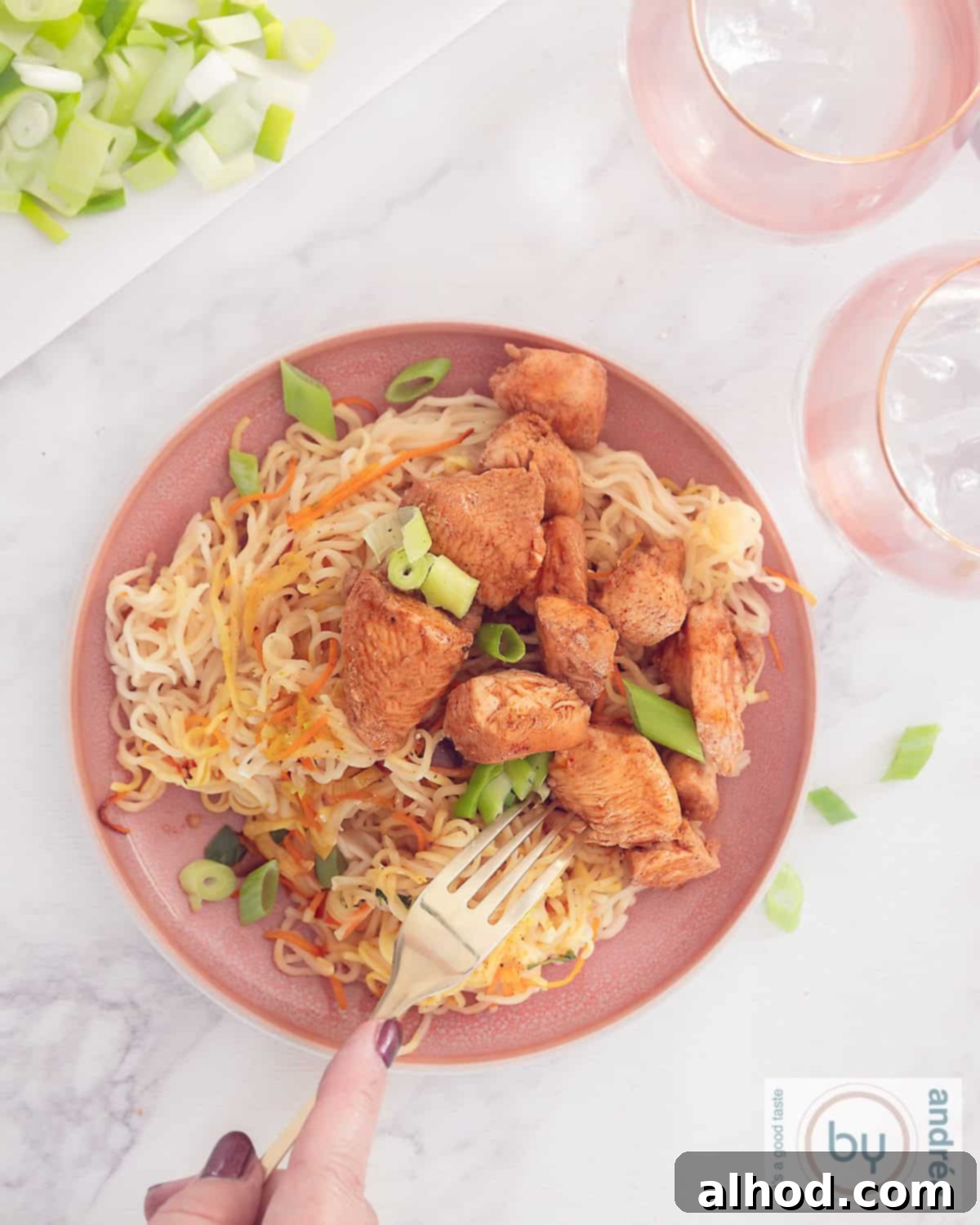 Cantonese Chicken with Egg Noodles Speedy Dinner 5 A photo from above of a pink plate with noodles, vegetables and diced chicken Cantonese style without packets and bags.