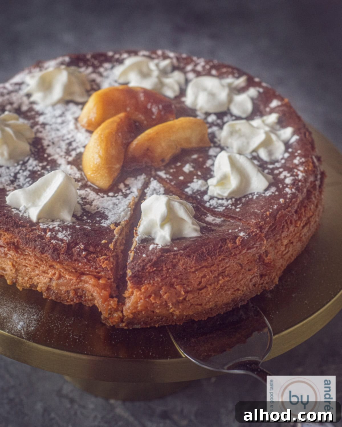 An aerial photo of an apple cheesecake with a slice cut out of it on a gold cake tin.