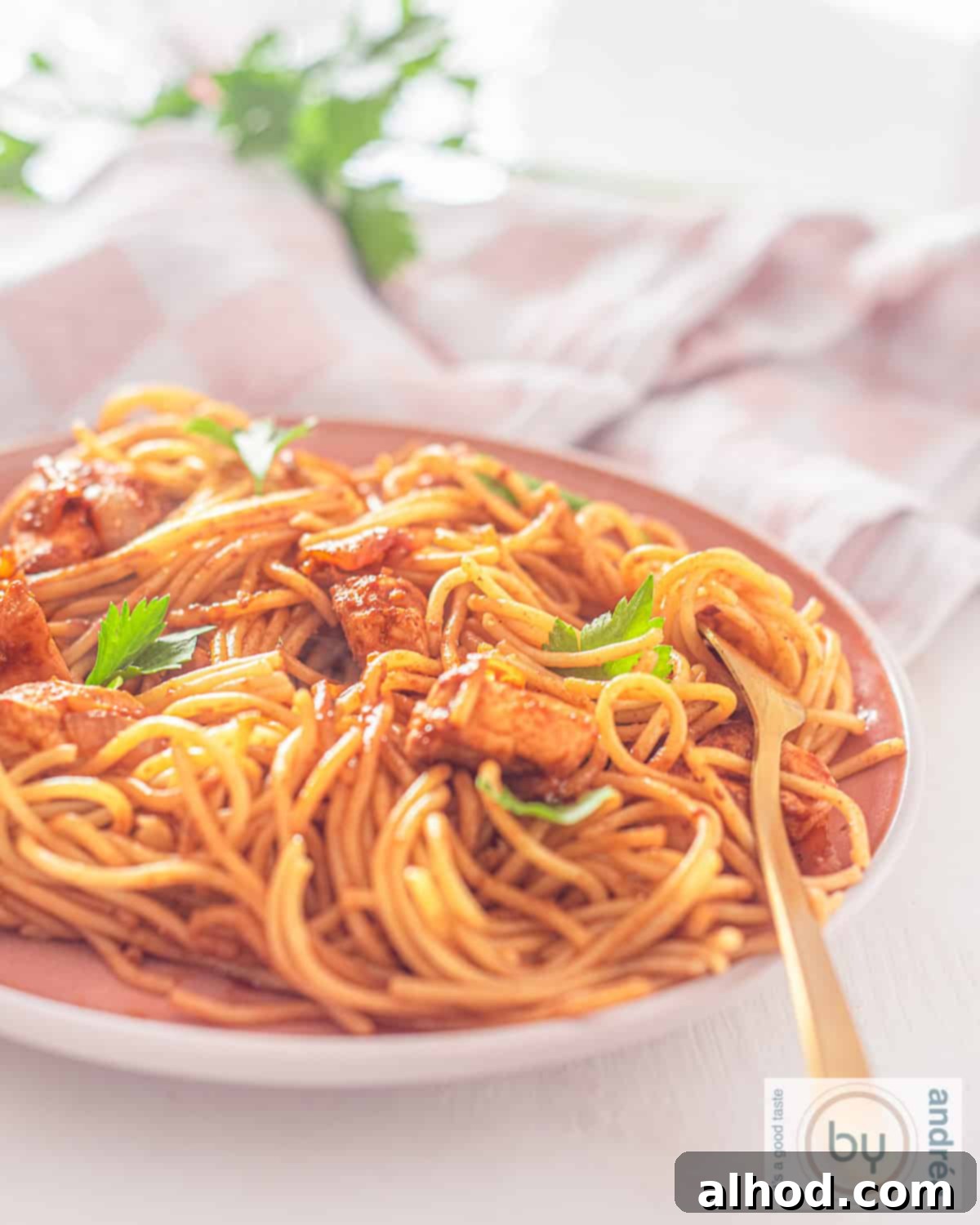 Whip Up Delicious Surinamese Bami Fast 5 Part of a pink plate filled with Surinamese Bami with delicious sauce, celery and chicken.