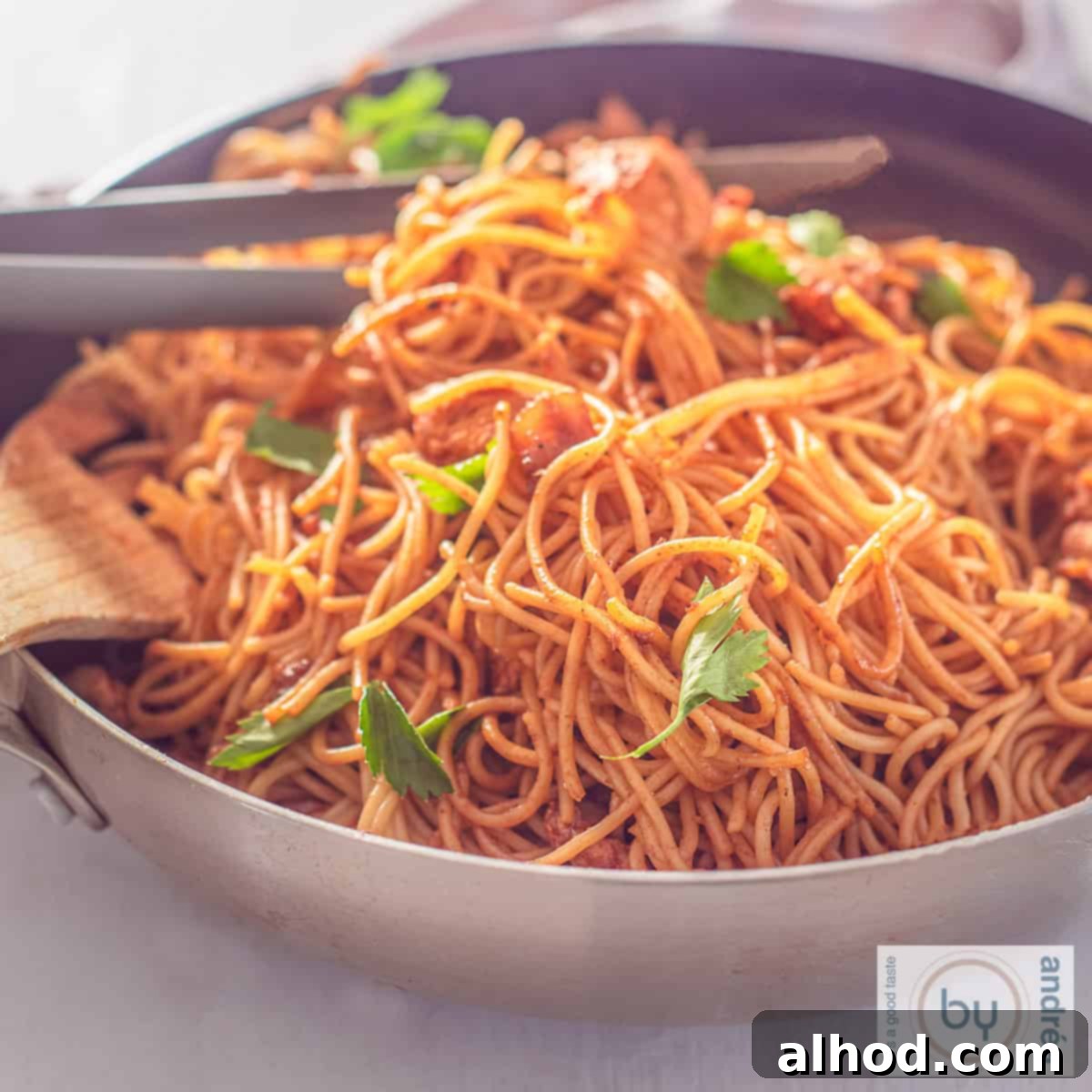 Whip Up Delicious Surinamese Bami Fast 6 A square photo with a wok filled with Surinamese style Bami with chicken and celery.