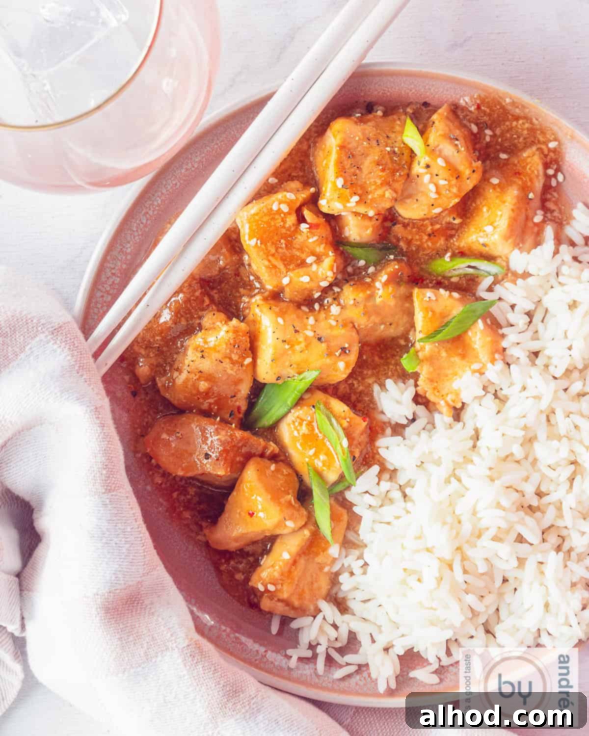 Effortless Slow Cooker Honey Garlic Chicken 2 A top down photo, half rice, half chicken with honey garlic sauce.
