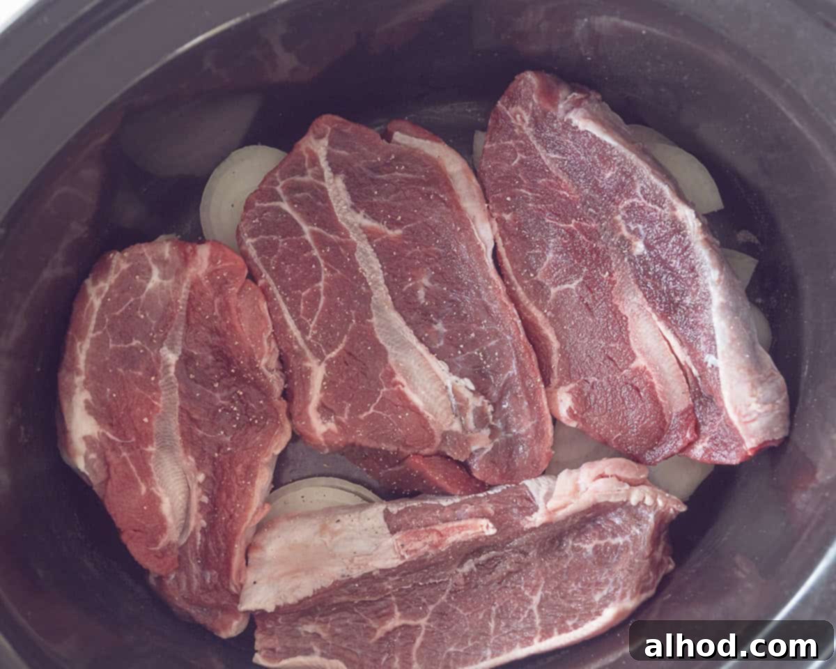 Melt-in-Your-Mouth Slow Cooker Dutch Sukadelapjes 4 A layer of onion with garlic and then blade steaks in the slow cooker