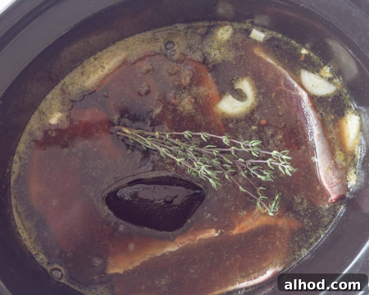 Melt-in-Your-Mouth Slow Cooker Dutch Sukadelapjes 5 Blade steak with apple butter, beer, stock and thyme in a slow cooker