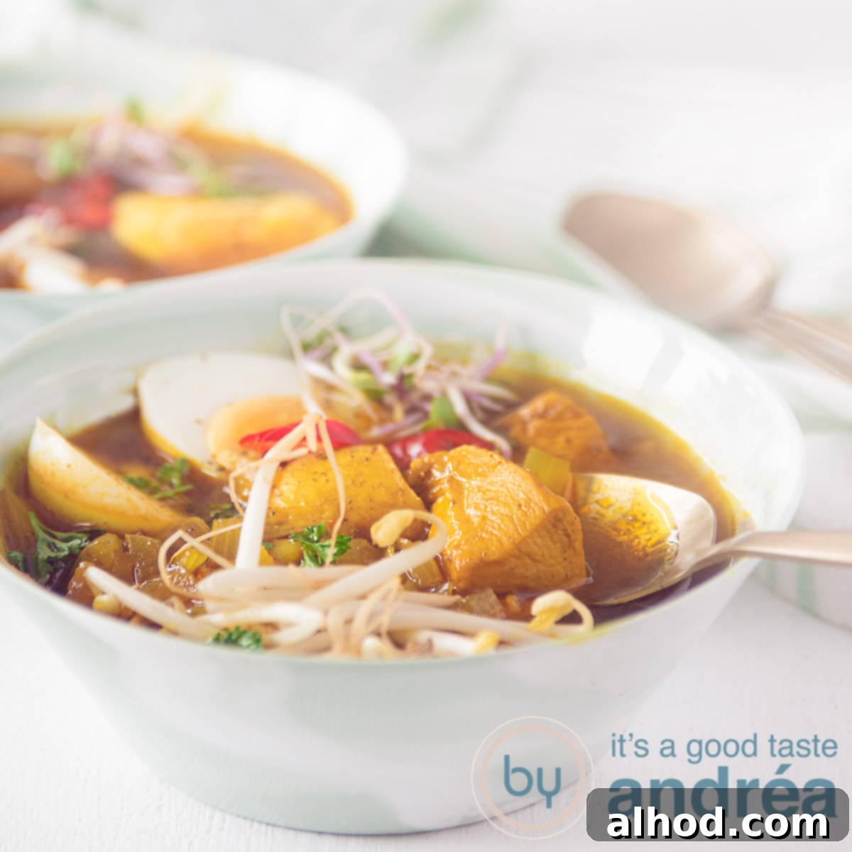 Taste Asia: Seven Soups You Can't Miss 7 A square photo with two green bowls filled with Asian-style chicken soup, bean sprouts, egg on a white background