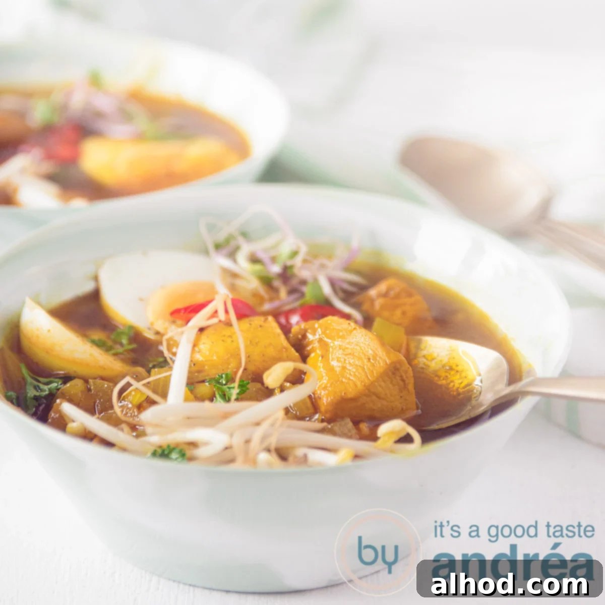 7 Incredible Asian Soups You Need to Taste 7 A square photo with two green bowls filled with Asian-style chicken soup, bean sprouts, egg on a white background