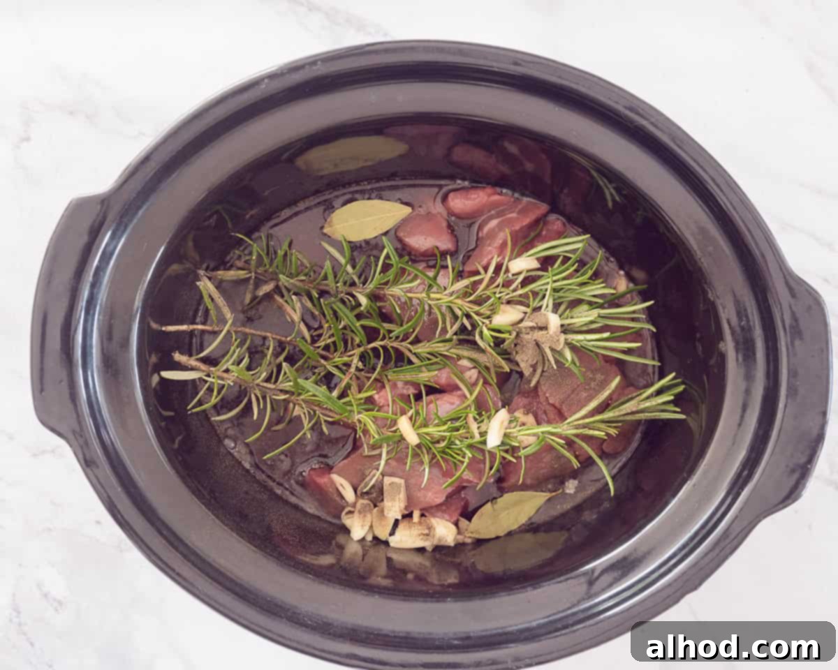 Peposo Tuscan Red Wine Beef Stew 6 Slow cooker filled with meat, wine, herbs and seasonings.