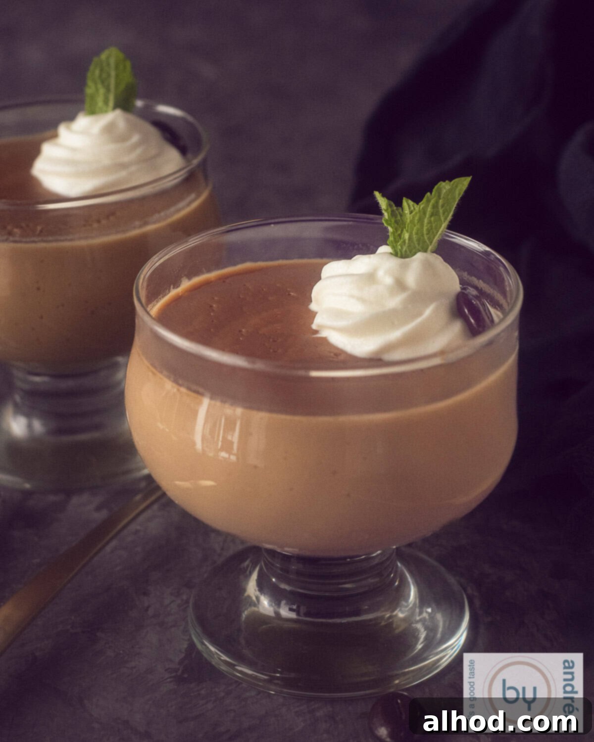The Ultimate Homemade Dutch Coffee Custard Delight 2 A height photo with two glasses diagonally behind each other with homemade hopjes custard and a dollop of whipped cream.