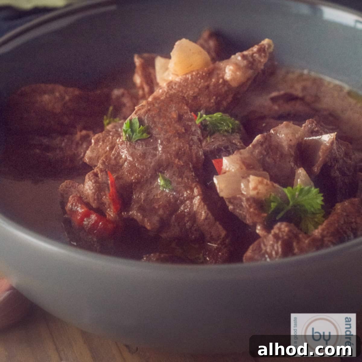 Melt-in-Your-Mouth Slow Cooker Beef Trinchado 4 A square photo with a gray bowl of beef trinchado from the slow cooker.