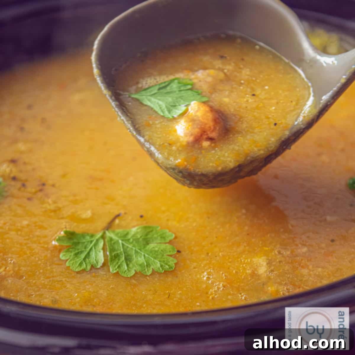 Cozy Creamy Slow Cooker Meatball and Vegetable Soup 4 A square photo of a slow cooker filled with creamy filled vegetable soup with meatballs