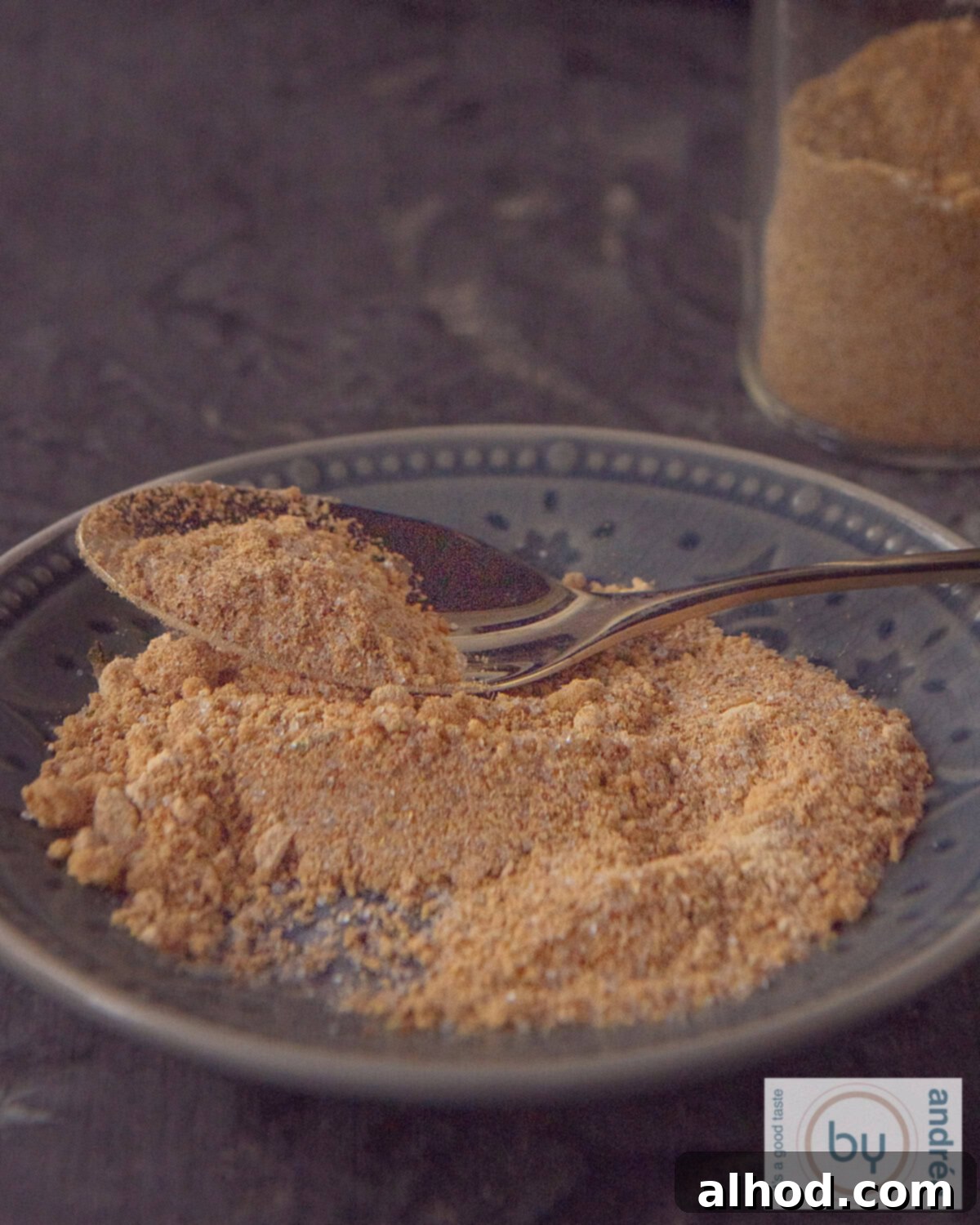 A gray saucer with homemade babi pangang spices, showcasing the vibrant, earthy blend ready for use.