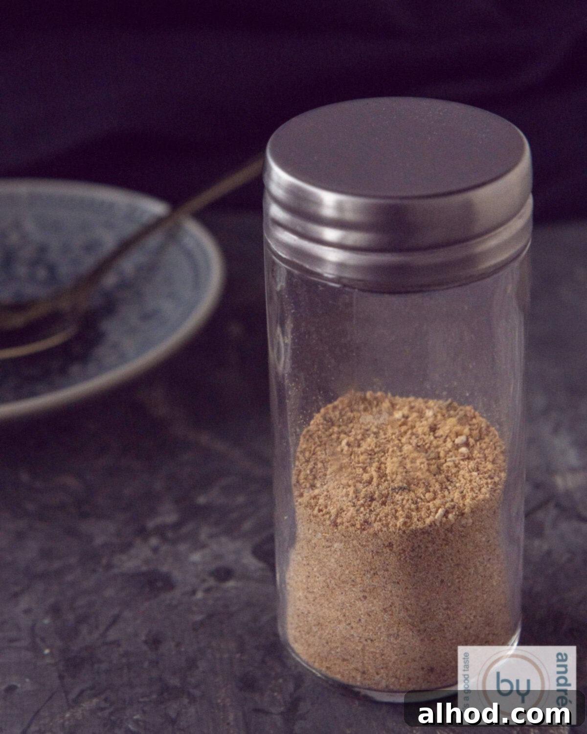 The Perfect Babi Pangang Spice Blend 3 A sealed glass jar filled with vibrant homemade Babi Pangang spice mix, ready for storage in a kitchen cupboard.