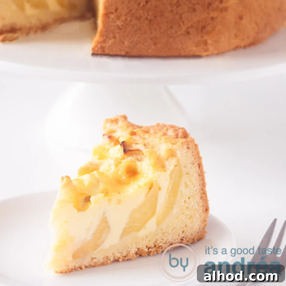 Classic Apple Custard Pie 6 A square photo with a piece of apple custard pie on a white background In the background the rest of the pie