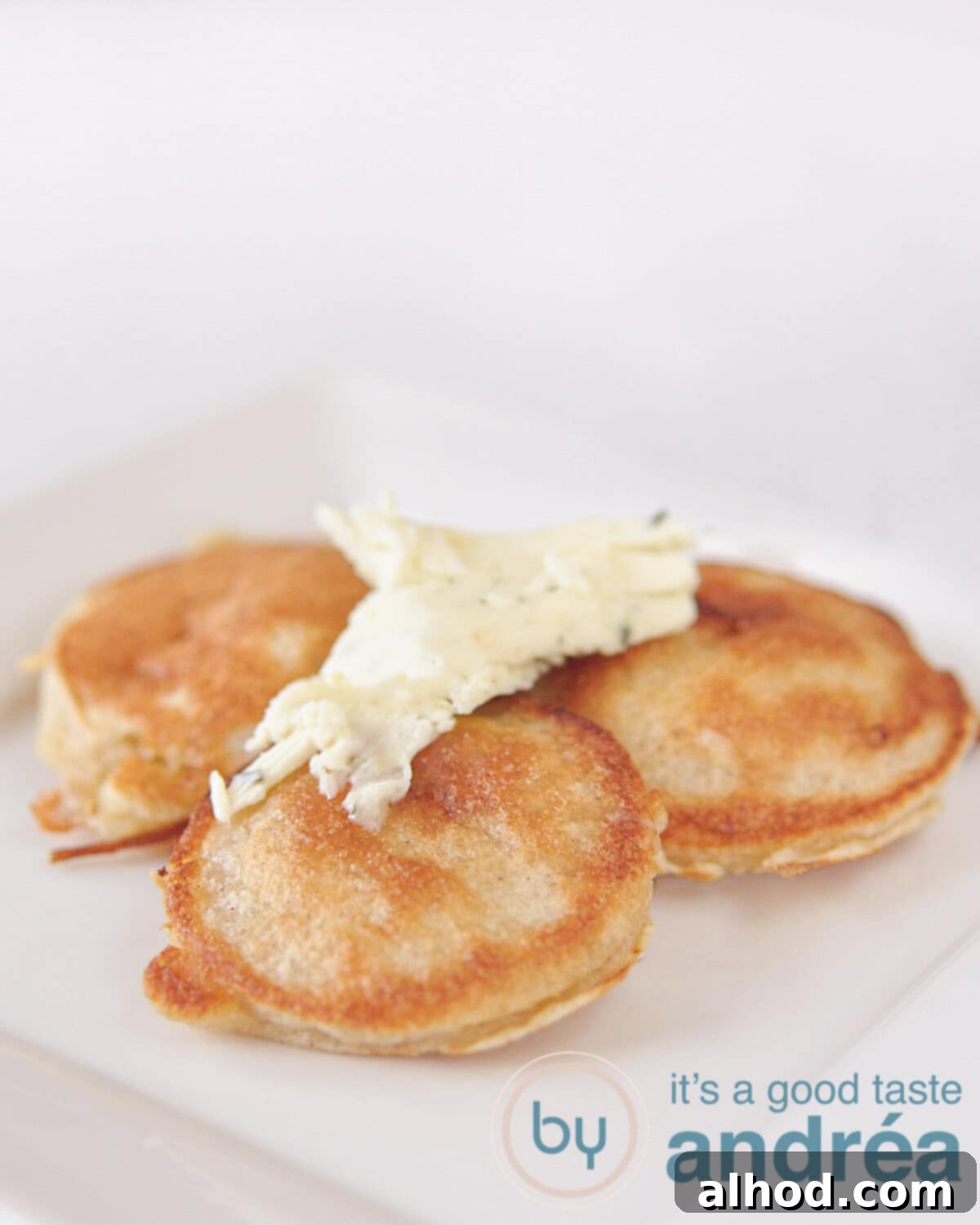 Irresistible Cheese Fritters with Hand-Crafted Garlic Butter 2 Plate of golden fritters generously topped with melting garlic butter, ready to be enjoyed.