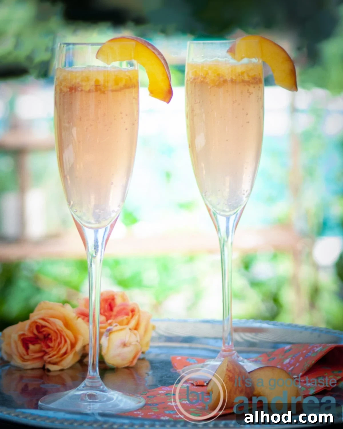 Peach Bellini 2 two glasses with Bellini cocktail and slices fresh peach