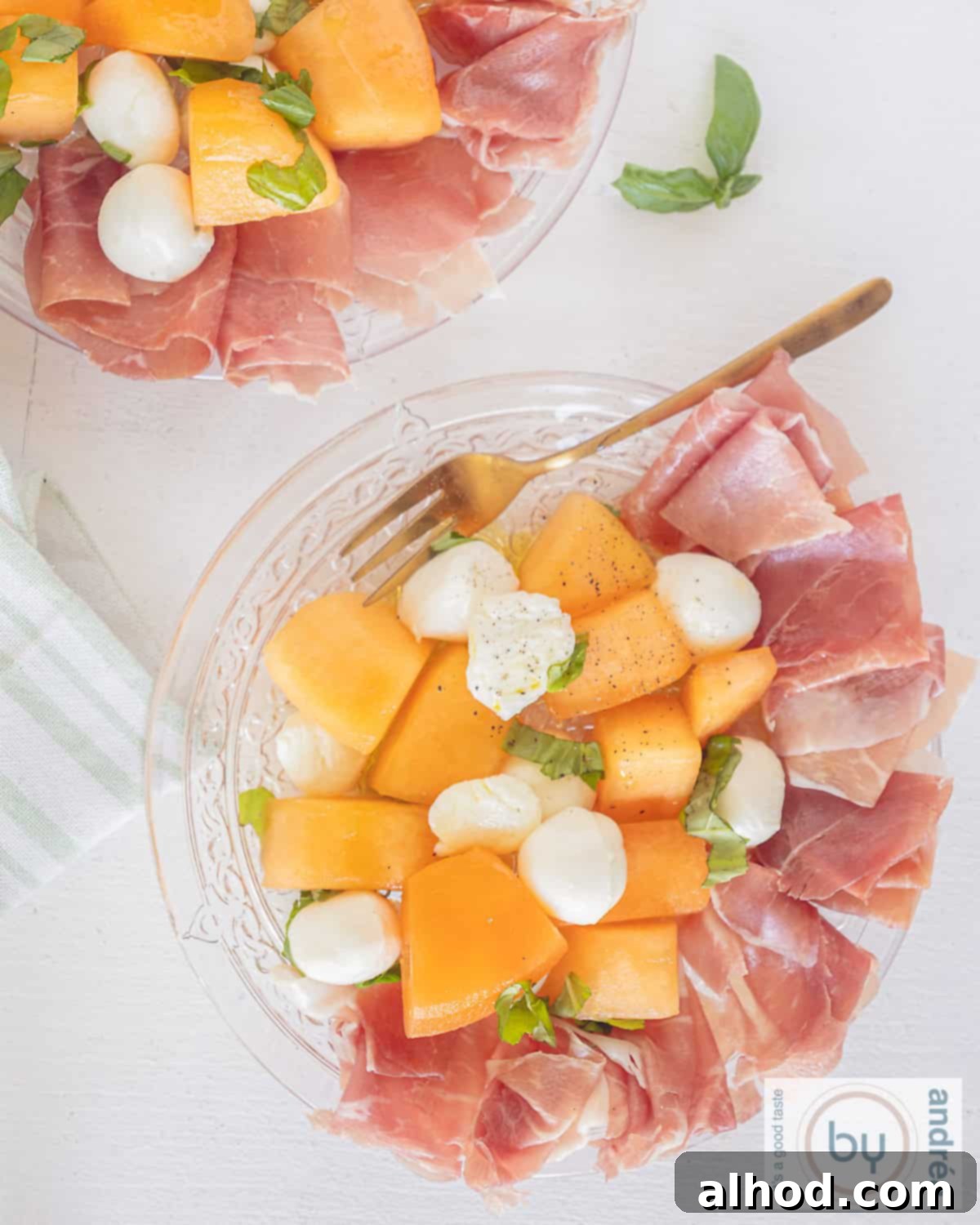 Vibrant Melon & Prosciutto Salad with Creamy Mozzarella 2 A picture taken from above from a plate with ham, cantaloupe and mozzarella arranged beautifully.