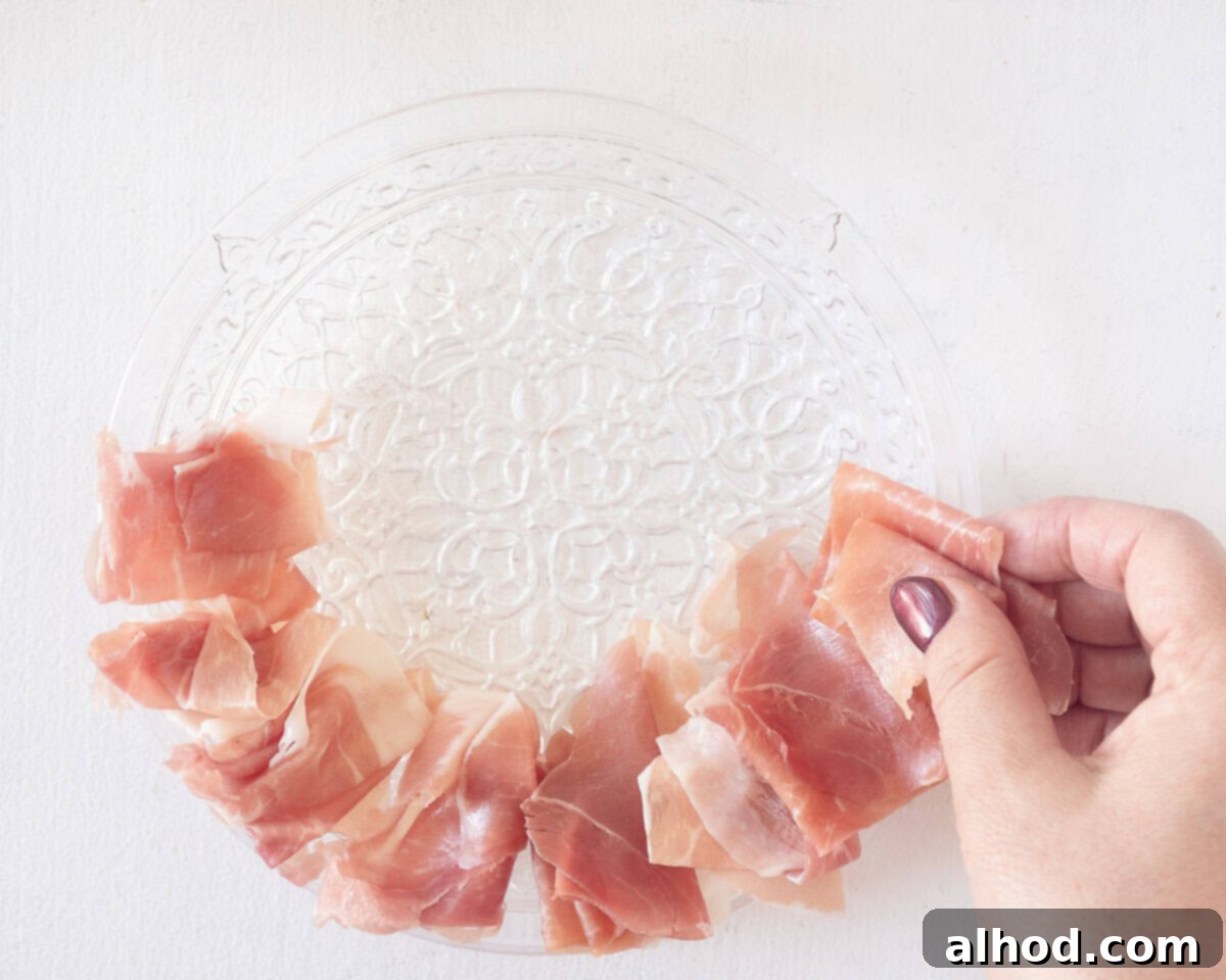 Vibrant Melon & Prosciutto Salad with Creamy Mozzarella 4 Place a border of parmaham on a plate