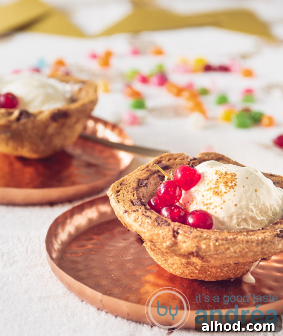 Two charming cookie baskets filled with creamy homemade vanilla ice cream and garnished with fresh red berries.