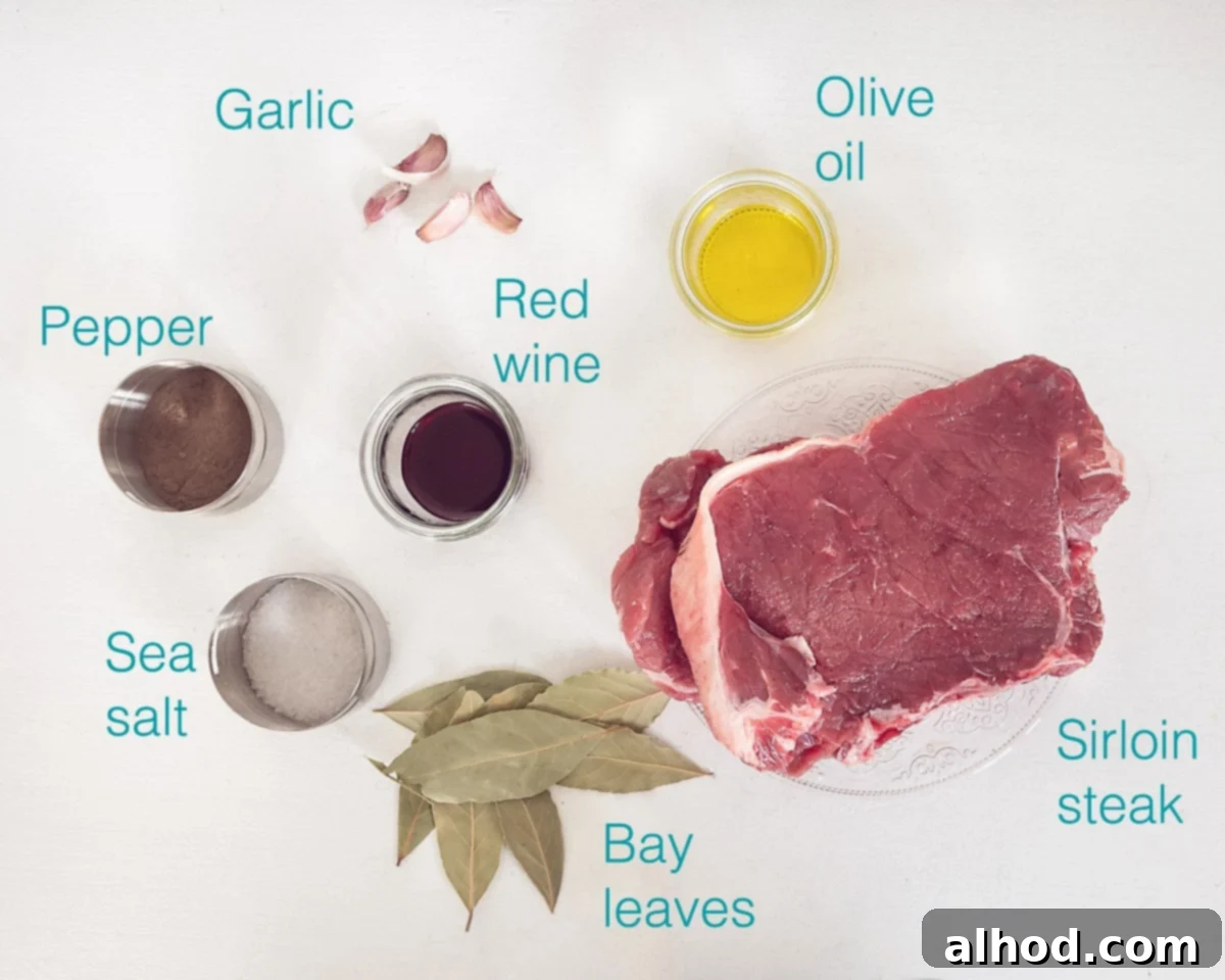 Espetada Madeira Beef Skewers 3 Ingredients Portuguese Beef Skewers (Espetada Madeira) on a white background with text describing the photo, including sirloin steak, garlic, olive oil, red wine, bay leaf, and sea salt.