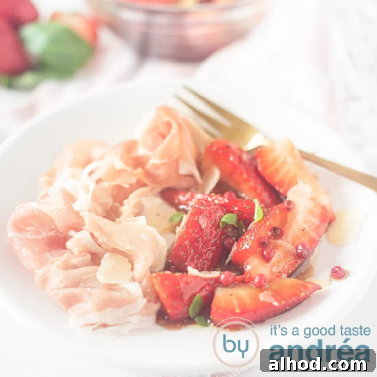Balsamic Basil Strawberry Bliss 6 A square photo with a white plate filled with balsamic strawberries, ham, a golden fork and the ingredients in the background