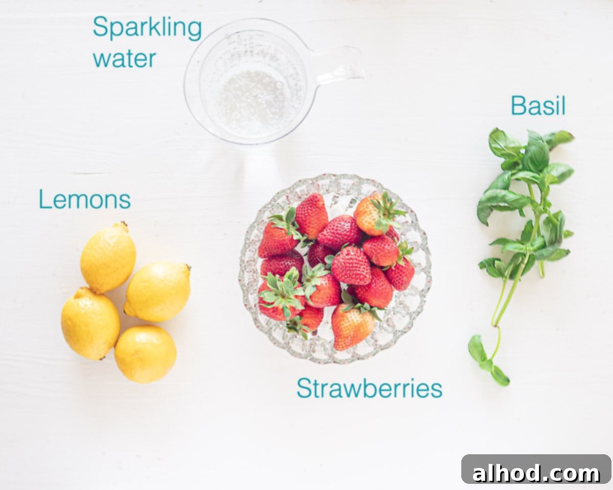 Strawberry Lemonade Mocktail with Basil 3 Fresh ingredients laid out on a white background, including ripe strawberries, bright yellow lemons, and vibrant green basil leaves, ready for making strawberry basil lemonade mocktails.