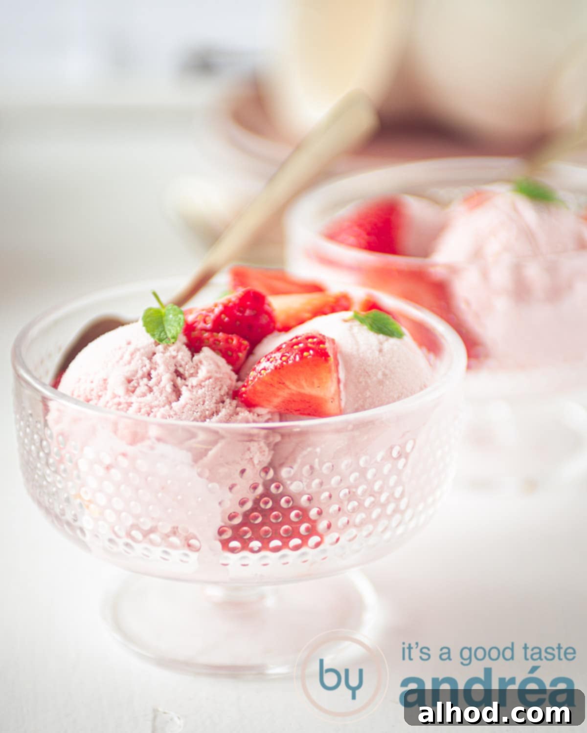 Easy No Churn Strawberry Ice Cream 5 two glass bowls with strawberry ice cream with fresh strawberries and mint