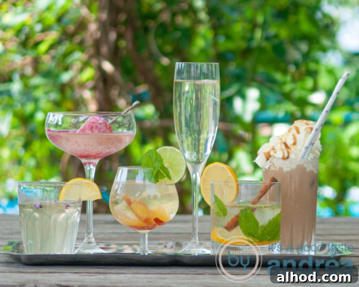 Six delicious summer drinks artfully arranged on a wooden table, set against a lush green background. The drinks vary in color and style, indicating a mix of cocktails and mocktails, perfect for warm weather enjoyment.