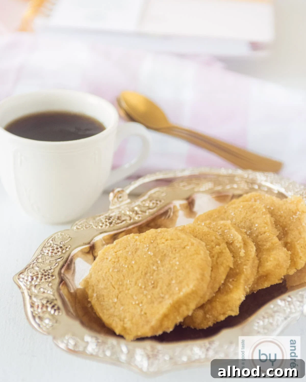 Crisp Ginger Shortbread Delights 5 An aerial photo showing a silver platter of cookies in a row served with a cup of coffee.